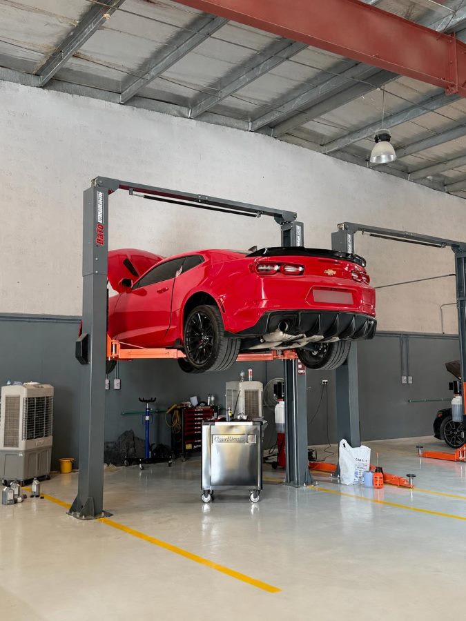 A car raised on a two-post lift for underbody work