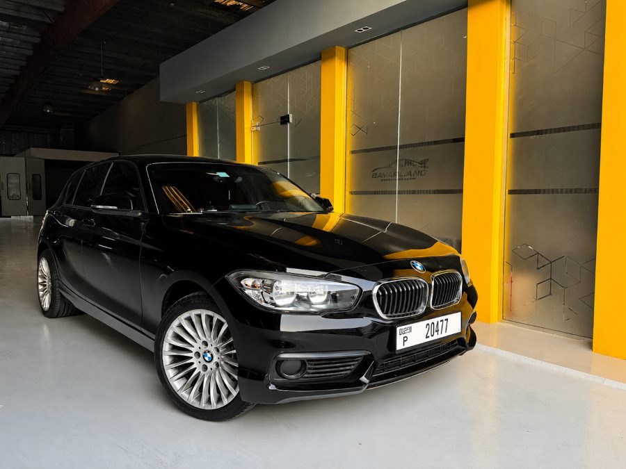 A BMW 1 Series in front of the BavarLand workshop entrance